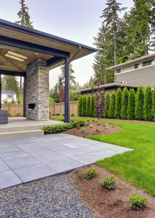 LN Landscaping, a one story home and backyard freshly landscaped with grass a pathway and modern features